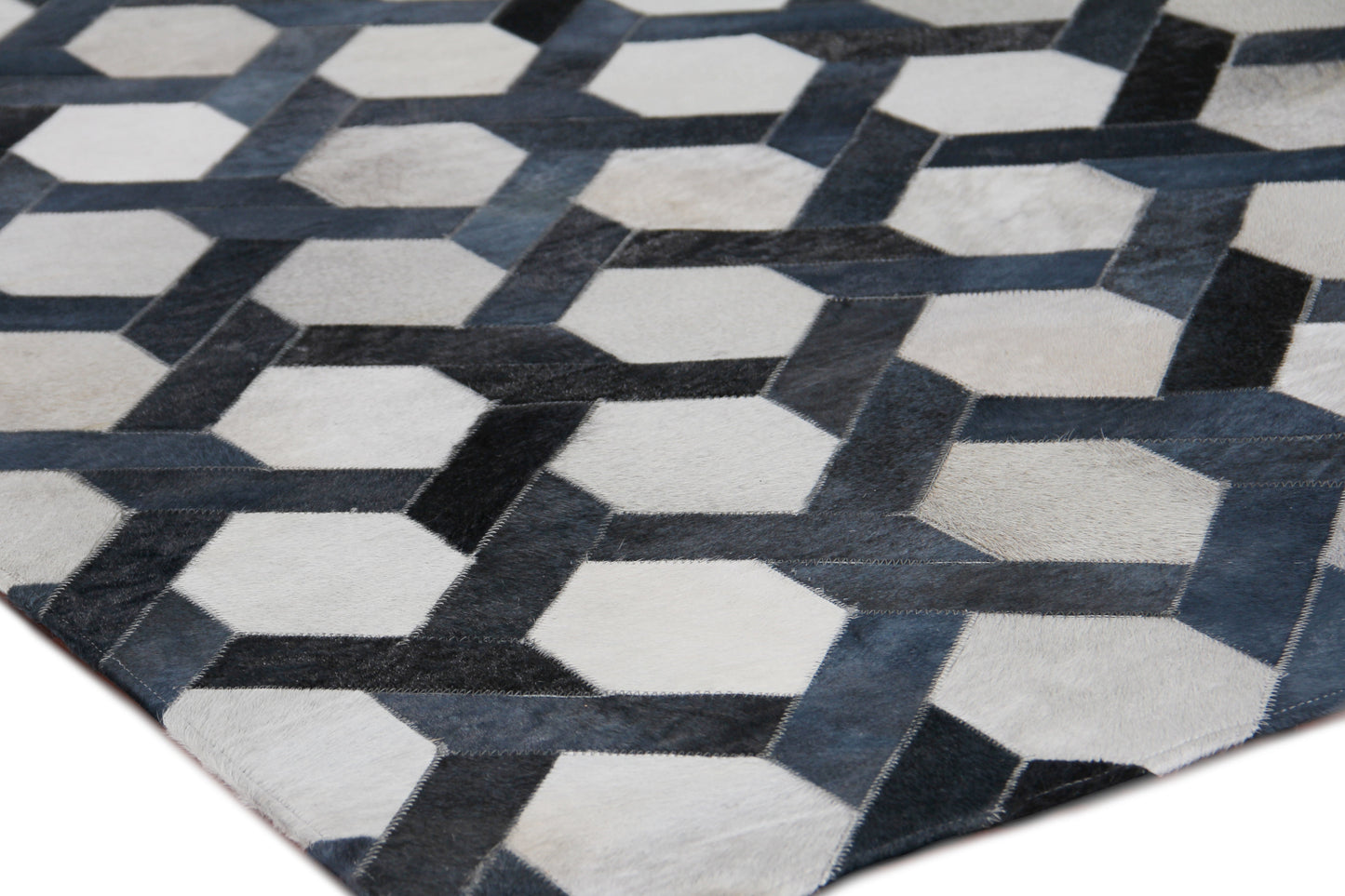 Natural hide indoor hand-stitched rug; showcases natural hide texture and artisanal stitching for modern home decor.