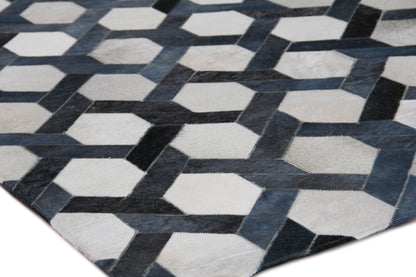 Natural hide indoor hand-stitched rug; showcases natural hide texture and artisanal stitching for modern home decor.