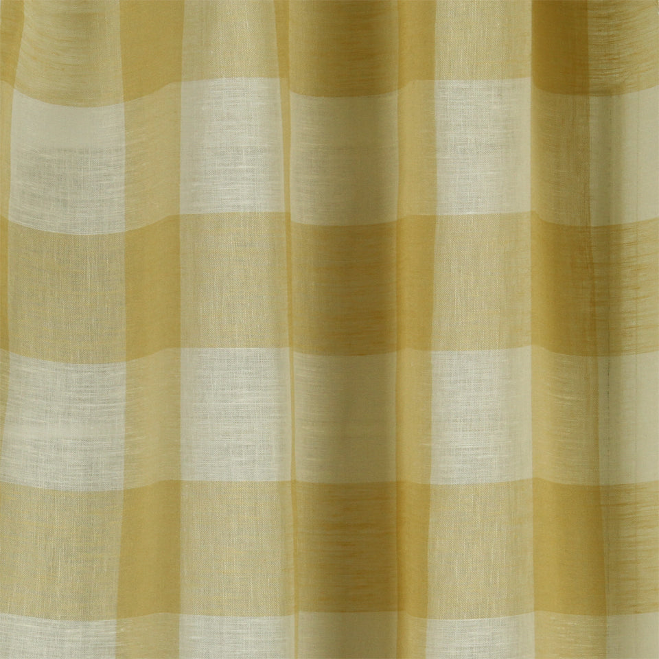 Yellow and white gingham fabric with soft pleats, ideal for curtains or light table linens.