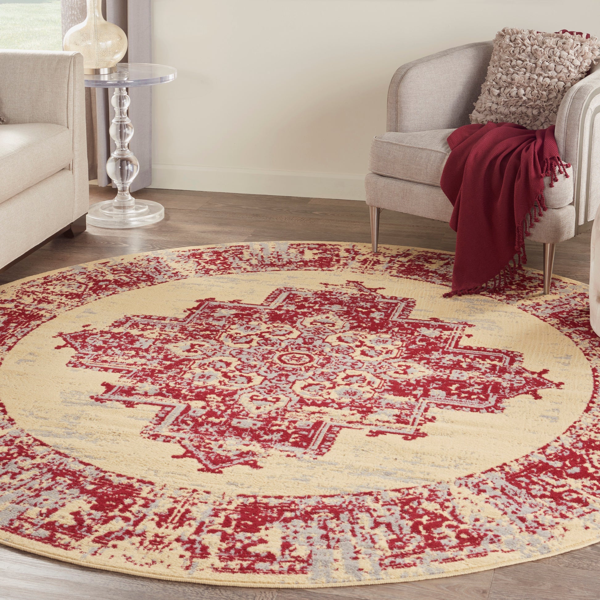 Round vintage-style oriental rug in cream with burgundy red medallion & light blue accents, soft pile for living room decor.