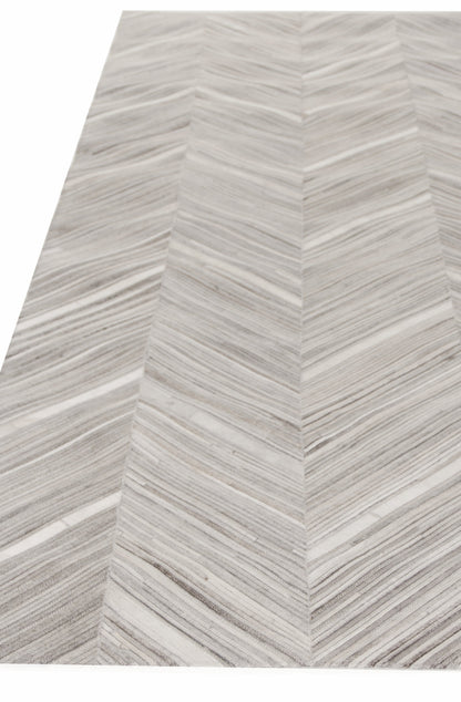 Light gray and white chevron rug with V-shaped stripe pattern and subtle texture.