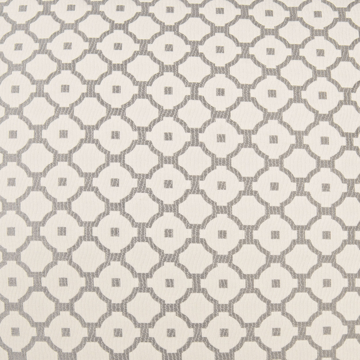 Cream fabric with gray repeating circular lattice & small center squares; geometric pattern on a pillow.