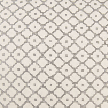 Cream fabric with gray repeating circular lattice & small center squares; geometric pattern on a pillow.