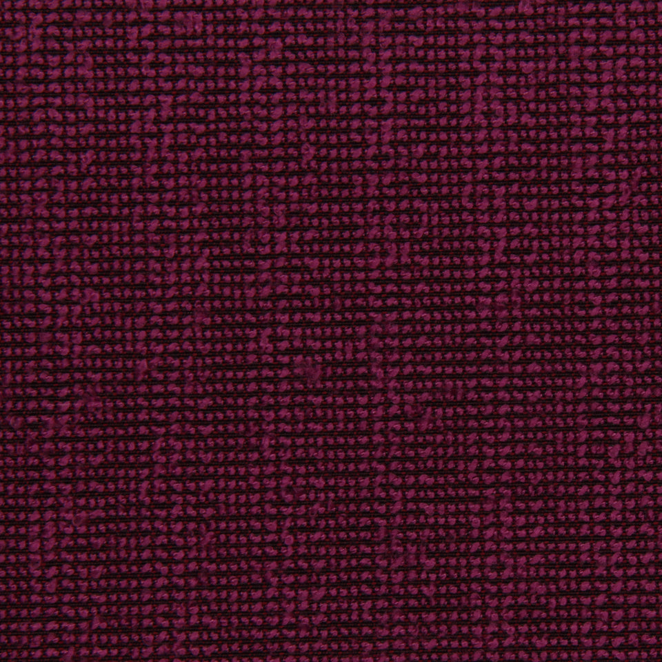 Close-up of orchid bouclé solid upholstery fabric, showing a textured looped weave.