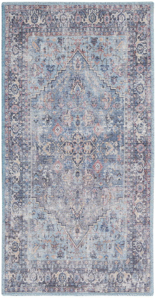 Blue-toned vintage oriental rug with central medallion, intricate floral border, distressed wash, fringed edges.