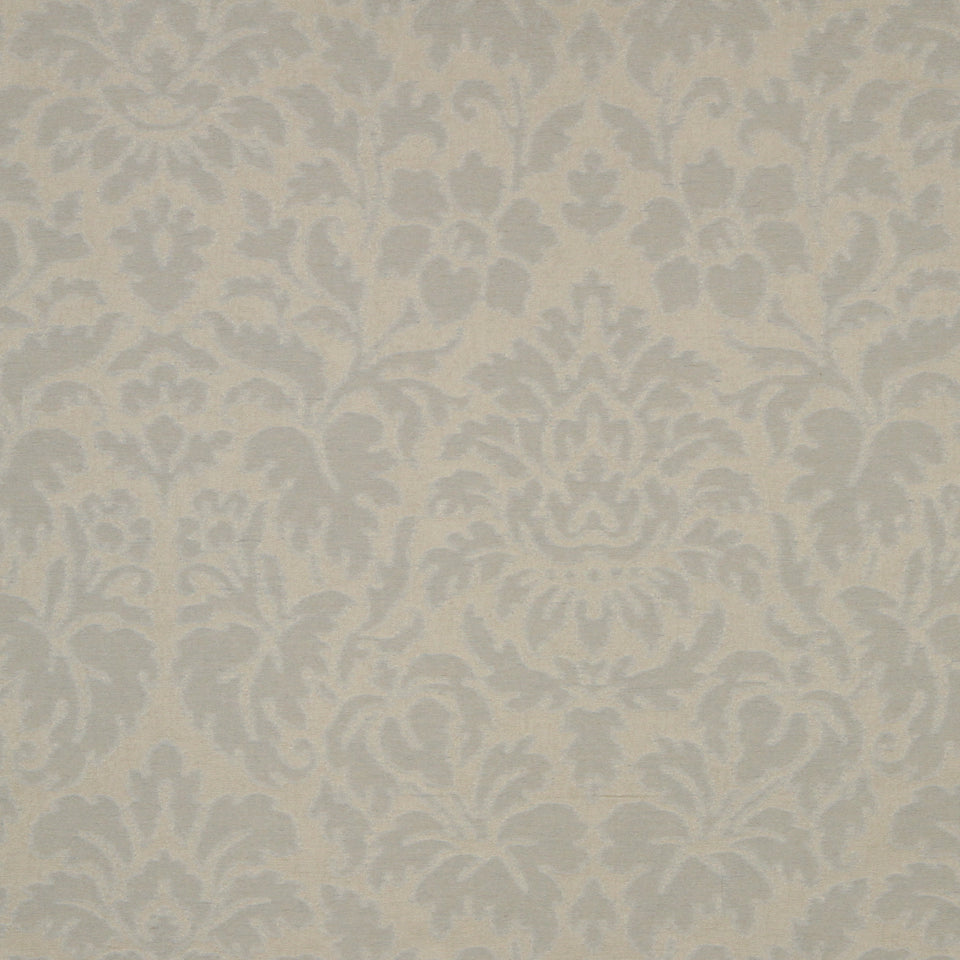 Beige damask upholstery fabric featuring an ornate floral scroll motif in soft cream tones.
