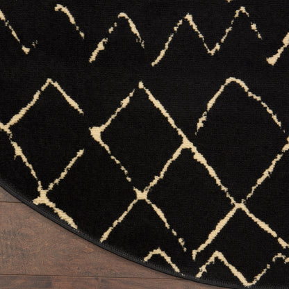 Round black rug with cream geometric diamond lattice; plush texture on wood floor.