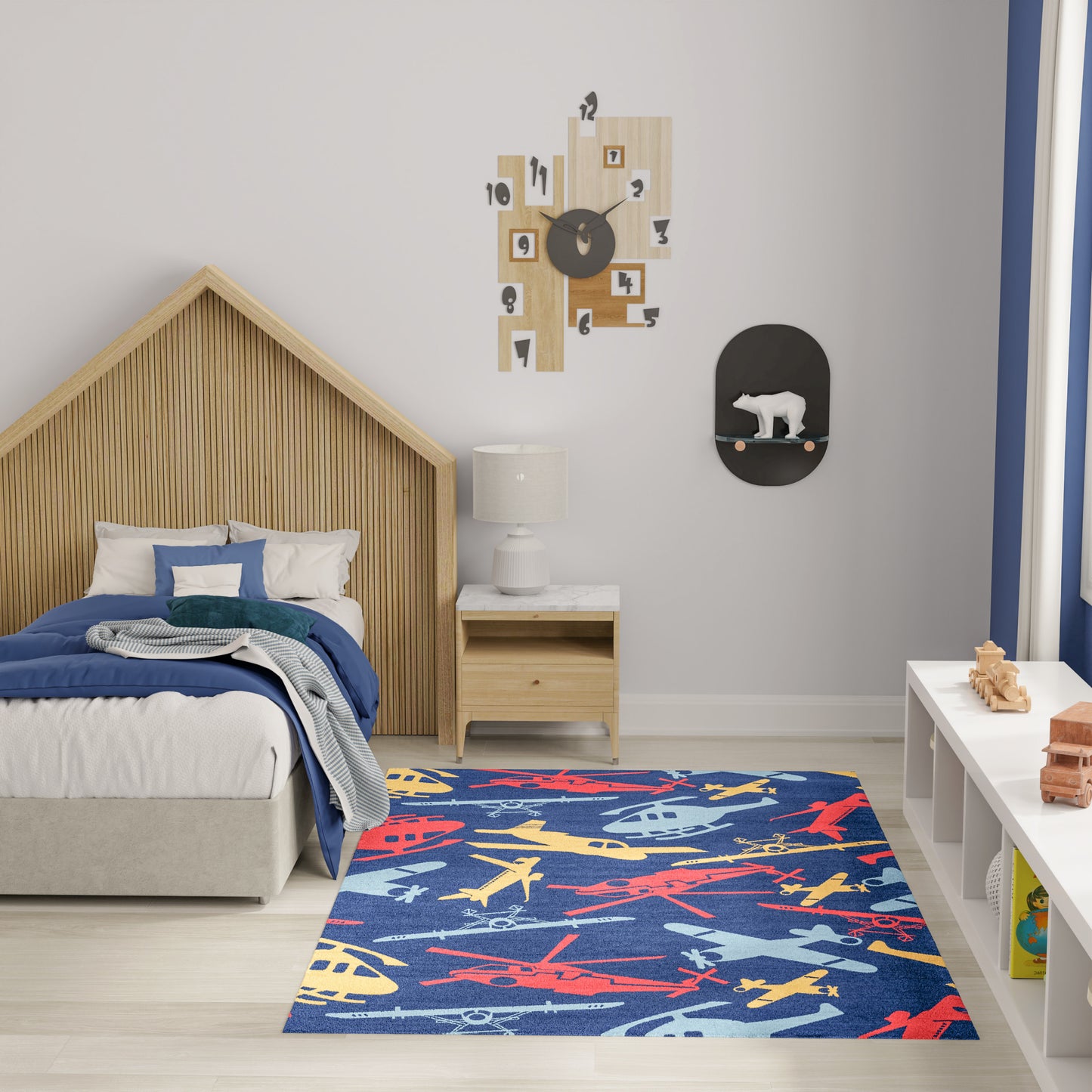 Kids bedroom with colorful airplane-pattern rug, house-shaped slat wooden bed, white bedding, and light wood nightstand.