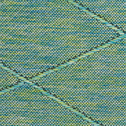 Close-up of teal and turquoise woven rug with raised braided lines forming a diamond pattern.