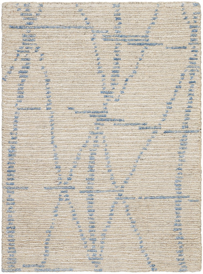 Beige woven rug with pale blue geometric lines in an abstract pattern; soft, textured surface.