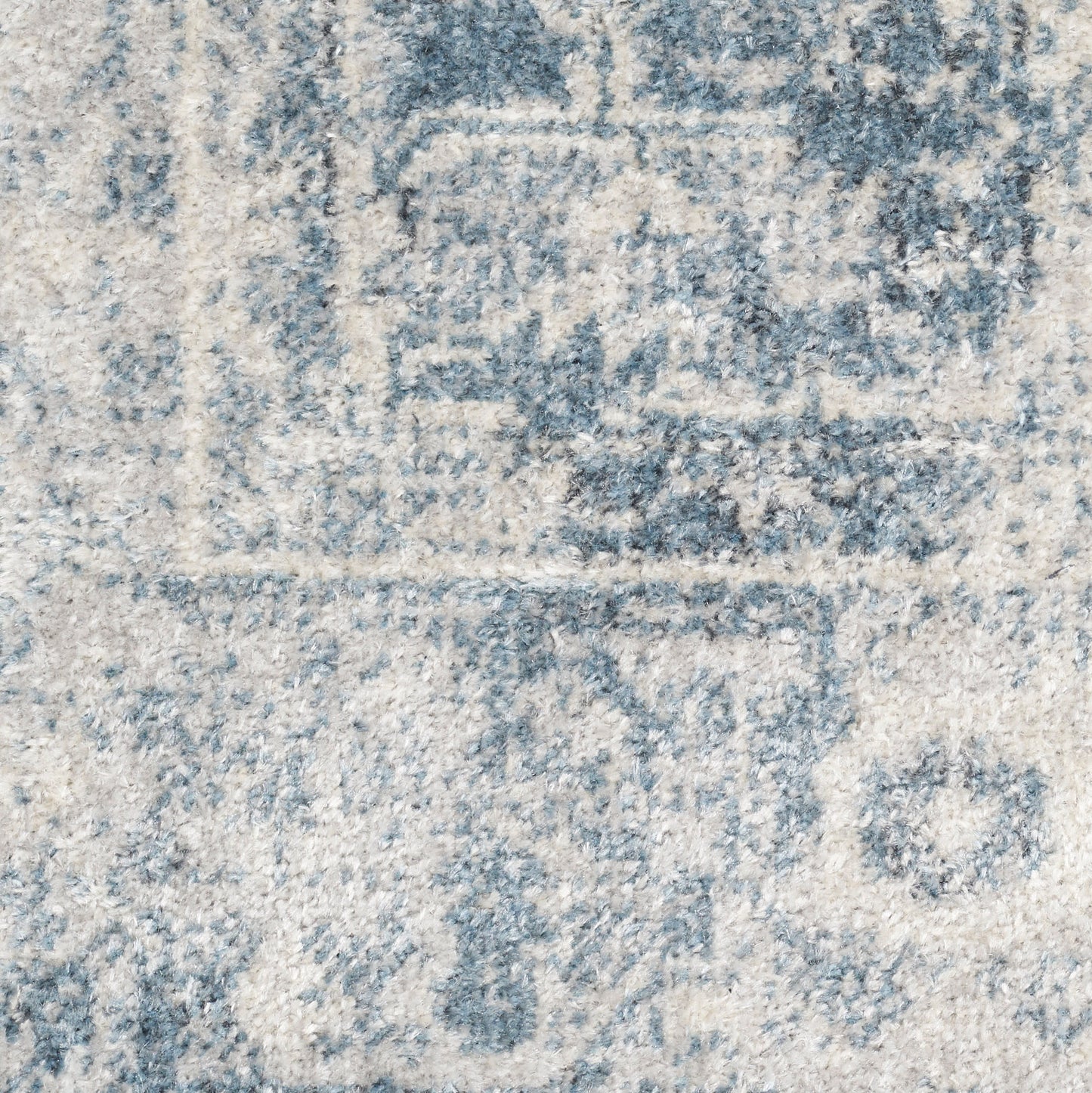 Blue & cream distressed runner rug with faded medallion pattern & soft textured pile.