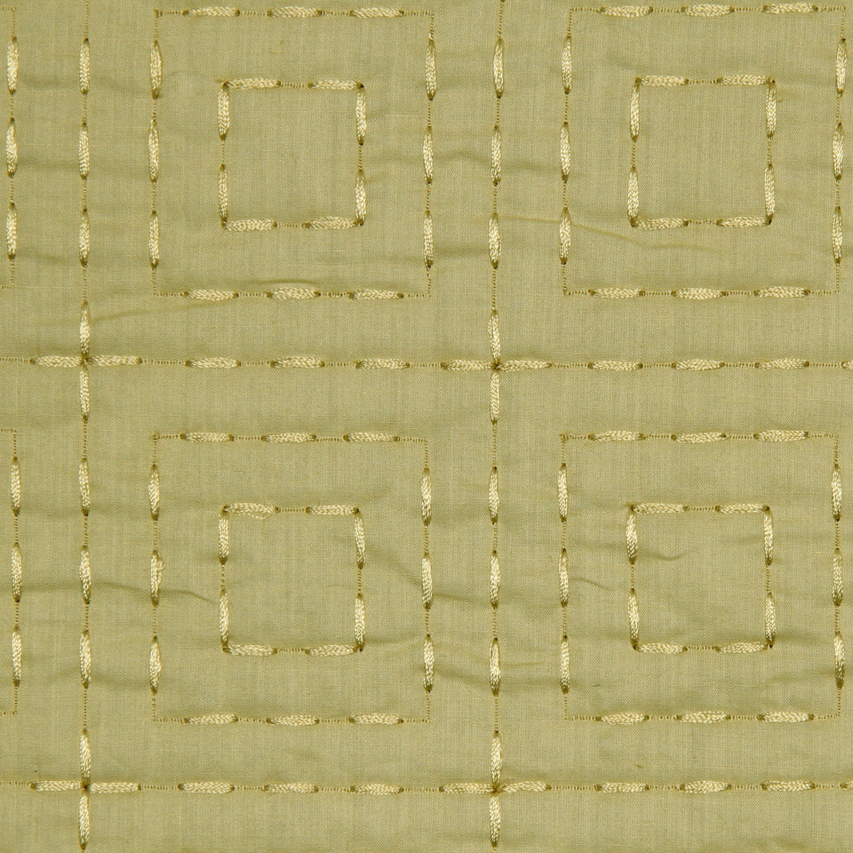 Beige linen fabric with gold metallic embroidery forming a grid of nested squares; geometric upholstery/drapery textile.