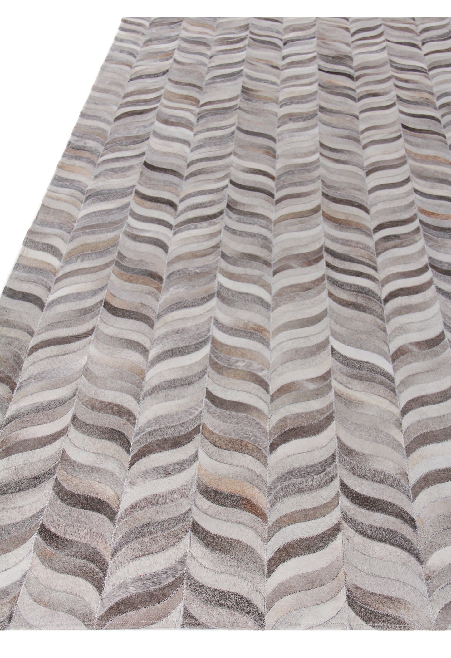 Natural hide rug, indoor hand-stitched, with an undulating striped pattern in gray, beige, taupe and ivory.
