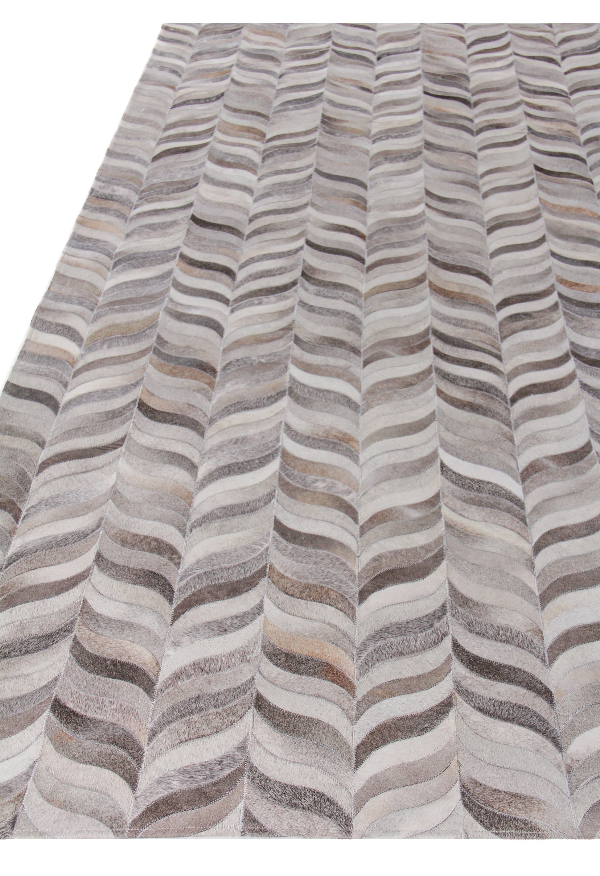 Natural hide rug, indoor hand-stitched, with an undulating striped pattern in gray, beige, taupe and ivory.
