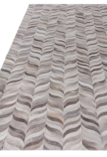 Natural hide rug, indoor hand-stitched, with an undulating striped pattern in gray, beige, taupe and ivory.