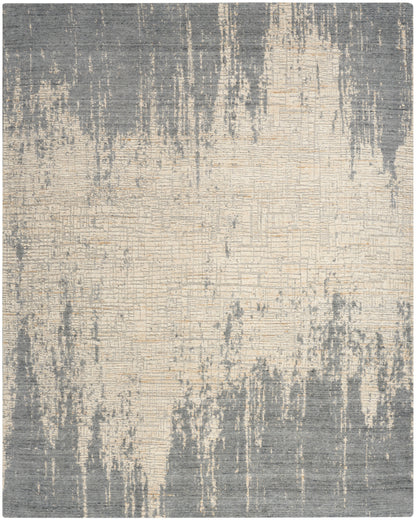 Abstract gray and beige area rug with distressed vertical streaks and soft woven texture.