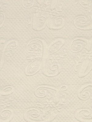 Cream textured wallpaper with subtle embossed scroll and flourish pattern, elegant wall coating.