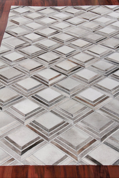 Geometric grey and beige rug with interlocking 3D diamond cube pattern on wooden floor.