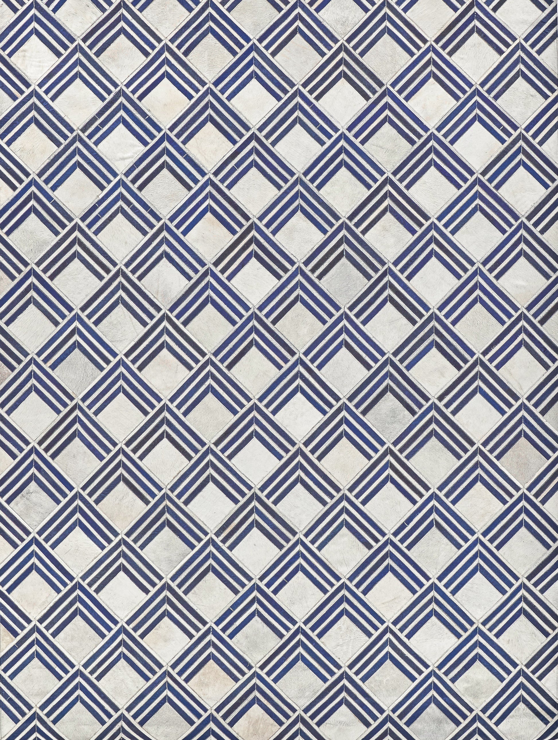 Blue and white diamond pattern on a natural hide rug; indoor hand-stitched.