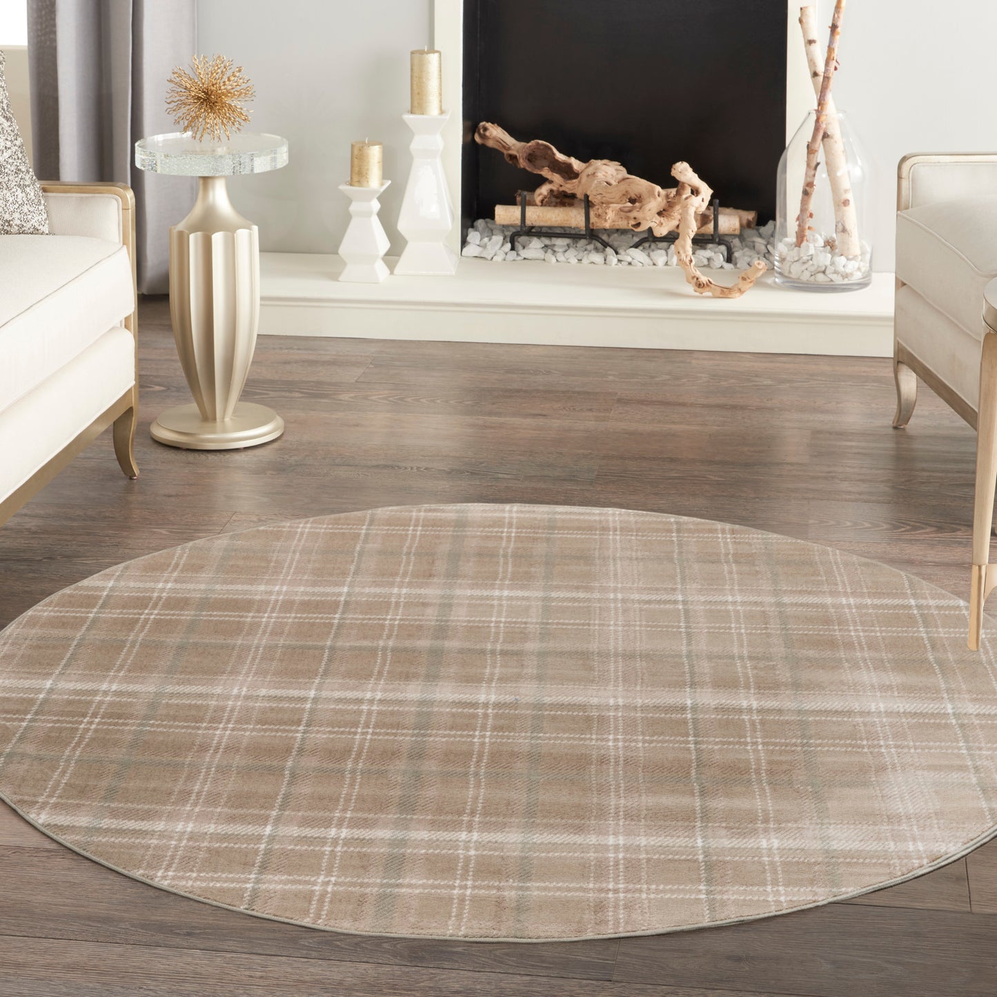 Beige round plaid area rug on dark wood floor in a modern living room with cream seating and a fireplace.