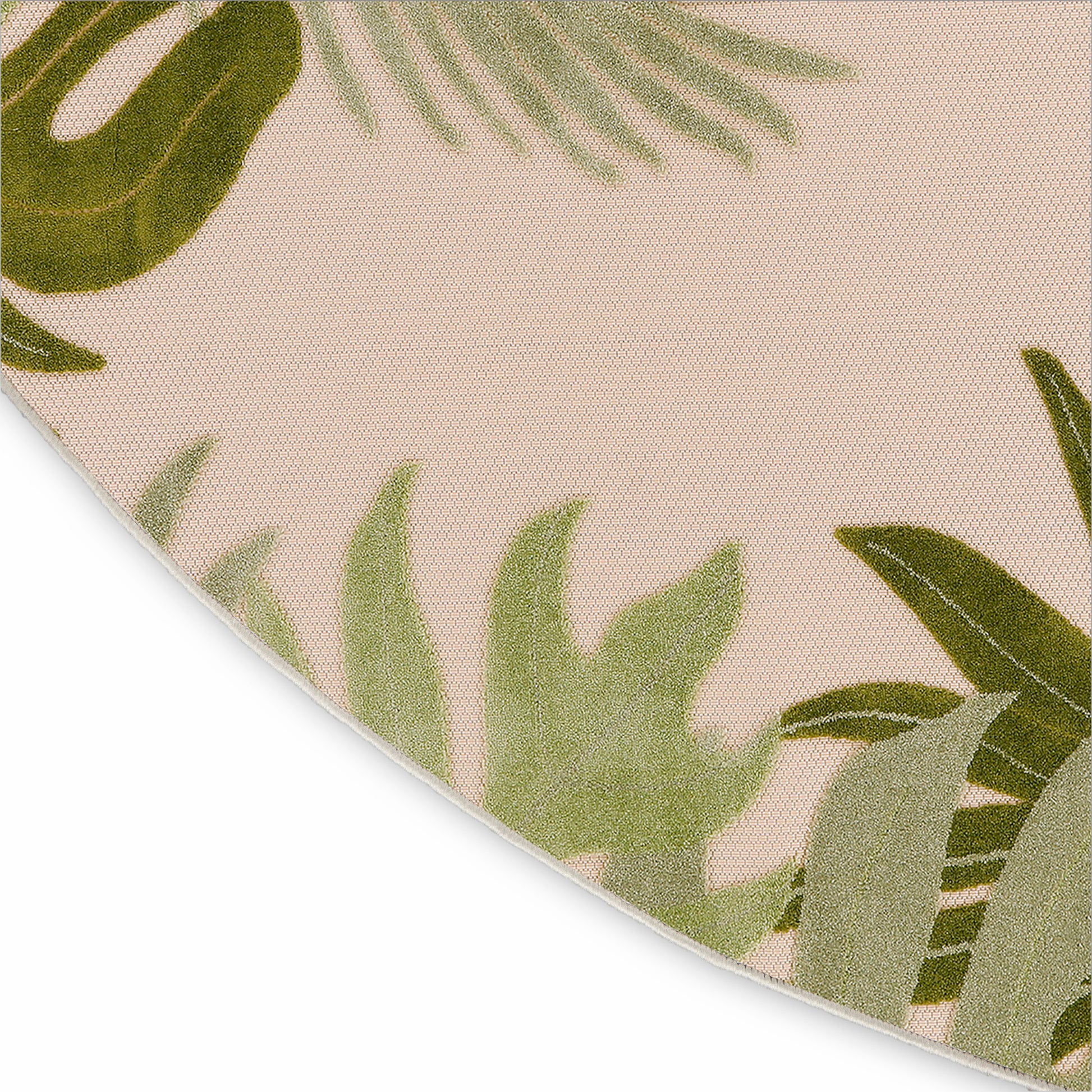 Beige round rug with green palm leaf pattern and woven texture.