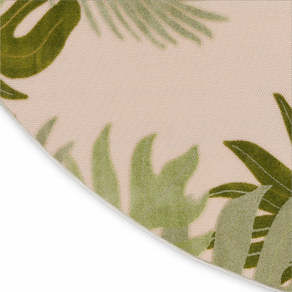 Beige round rug with green palm leaf pattern and woven texture.