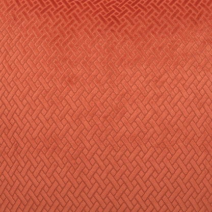 Rust-orange woven fabric with a repeating basket-weave pattern and textured upholstery-ready surface.