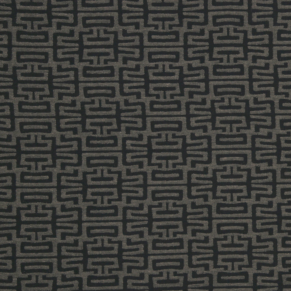 Dark charcoal fabric with taupe geometric Greek-key-inspired interlocking pattern; ideal for upholstery or drapery.
