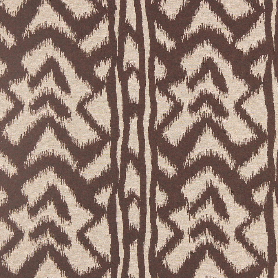 Brown and beige ikat-inspired fabric with bold zigzag chevron pattern and vertical stripe motif.