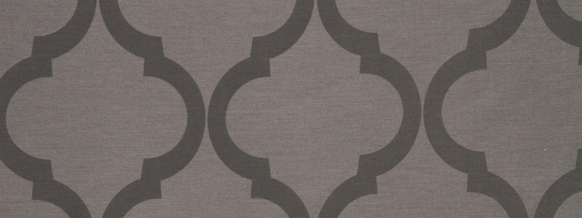 Grey patterned wallpaper with repeating interlocking quatrefoil motifs in dark charcoal on light taupe