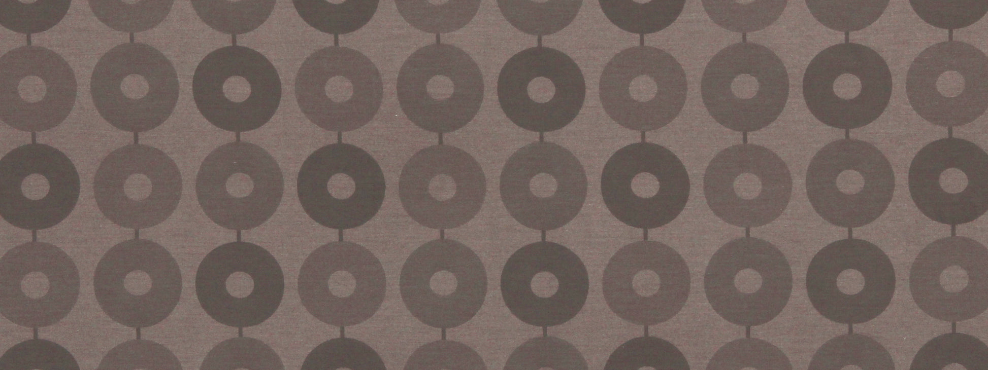 Dark chocolate fabric with a repeating donut-circle pattern; retro geometric upholstery textile.
