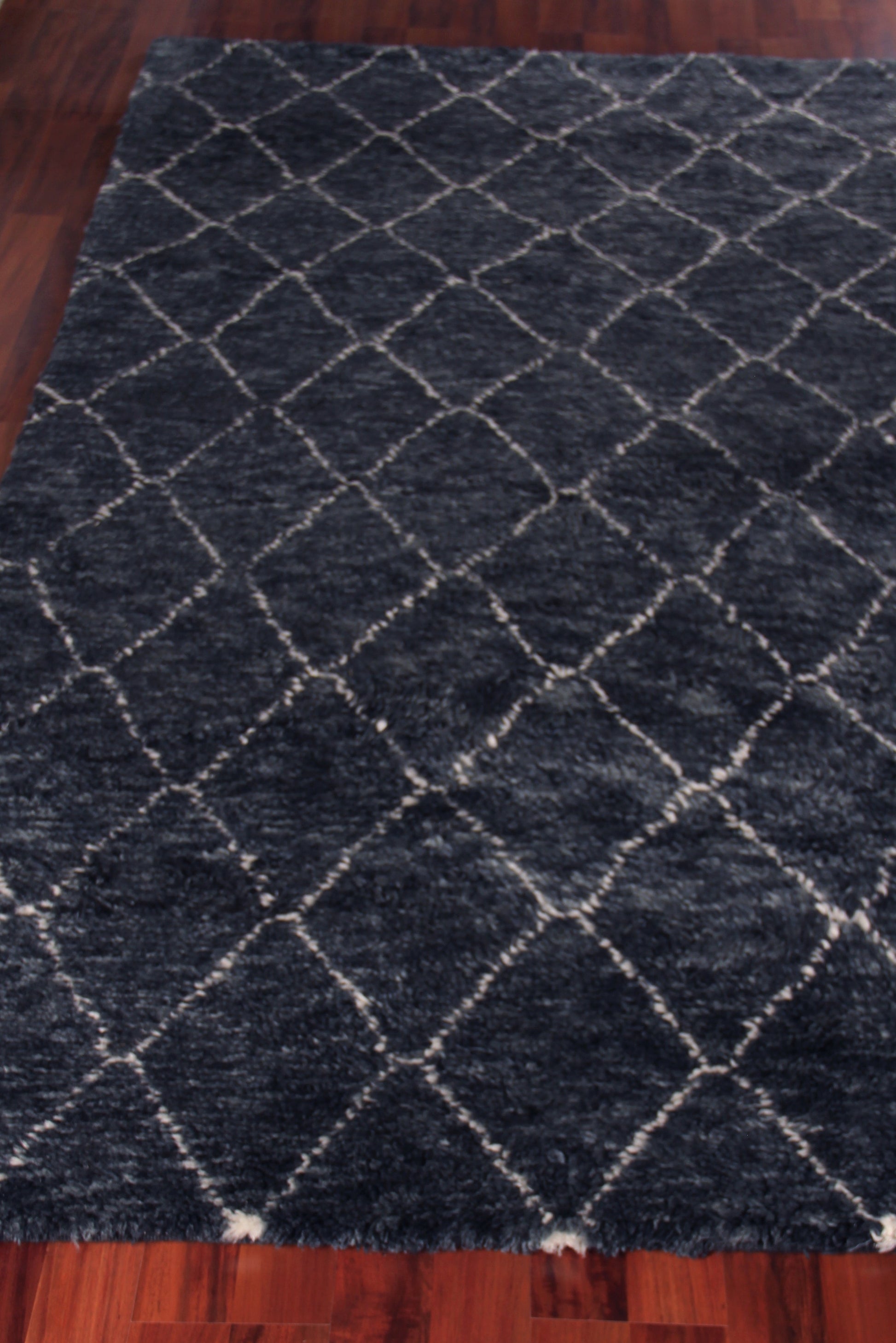 Dark navy Moroccan indoor hand-knotted rug with white diamond pattern, rectangular living room area rug.