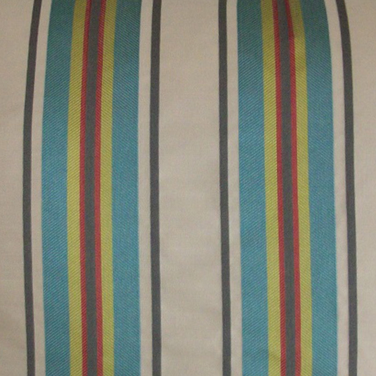 Vertical striped pillow with teal and cream base and bright yellow, red and navy accents.