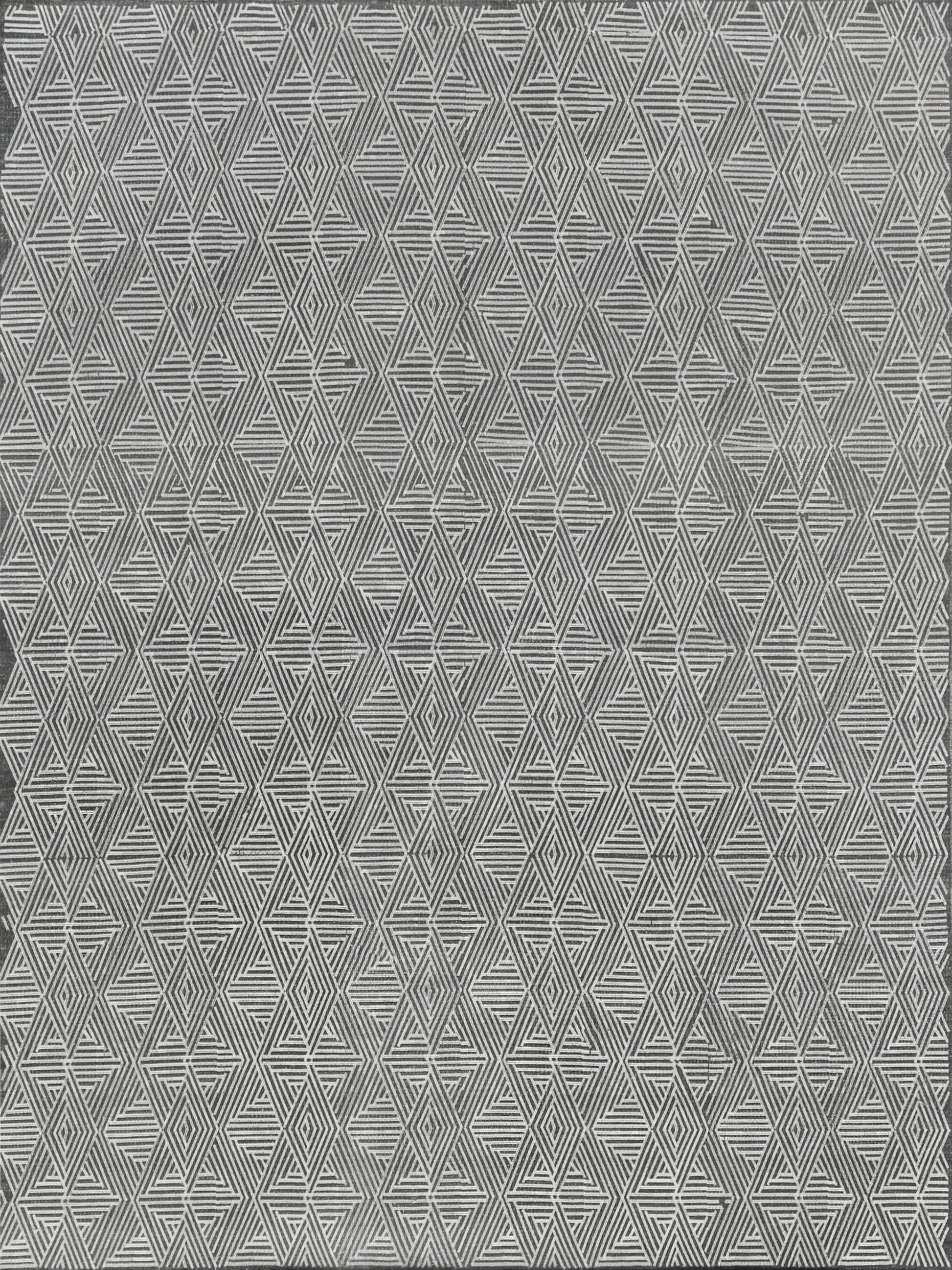 Grey flat-weave rug with a white repeating diamond and triangle pattern; indoor use.