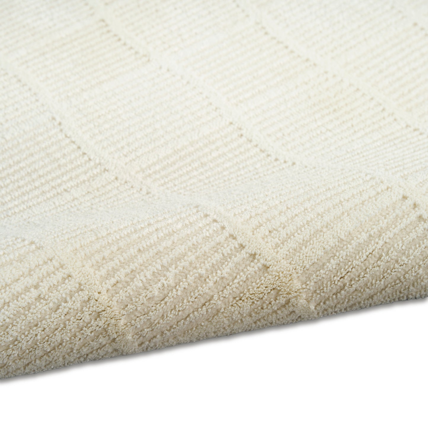 Cream rectangular rug with subtle square geometric pattern in looped pile; soft, neutral home decor.