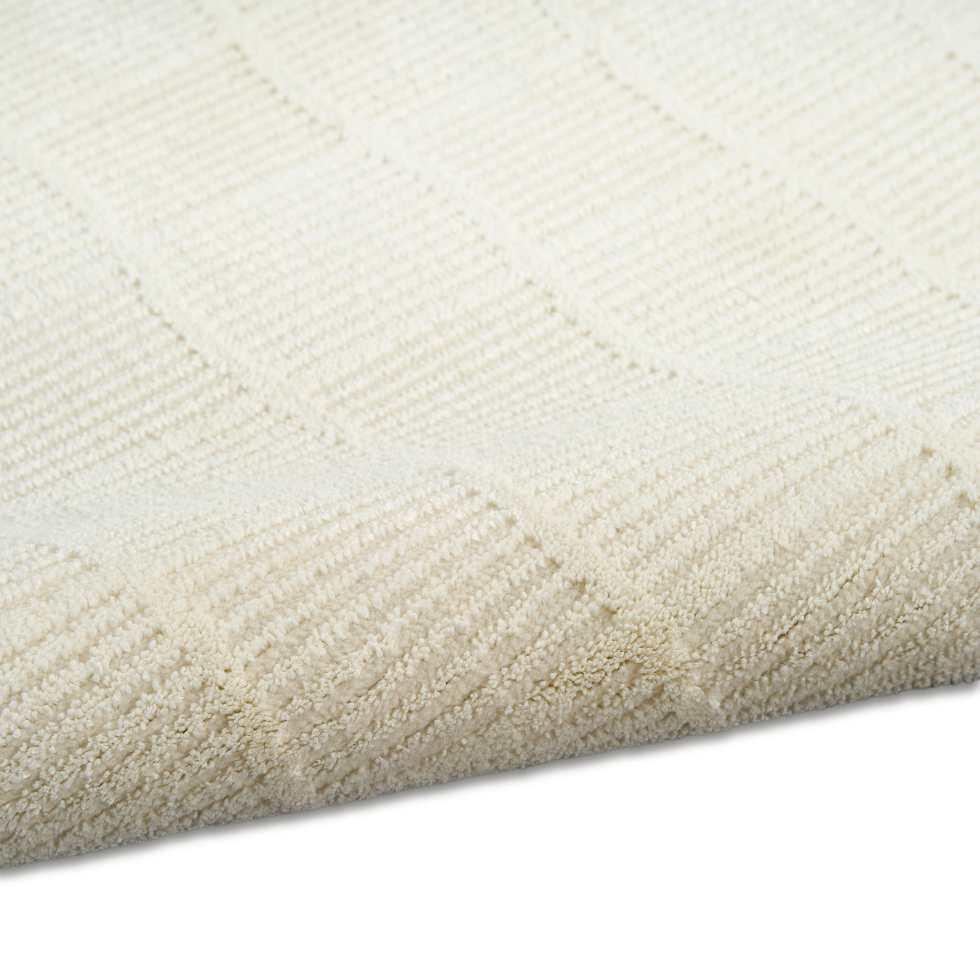 Cream rectangular rug with subtle square geometric pattern in looped pile; soft, neutral home decor.