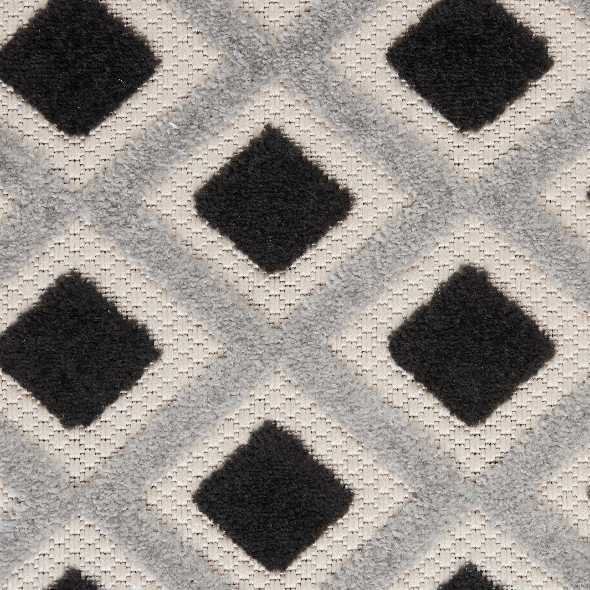 Light gray runner with black diamond geometric pattern; tufted, modern decor piece for living spaces.