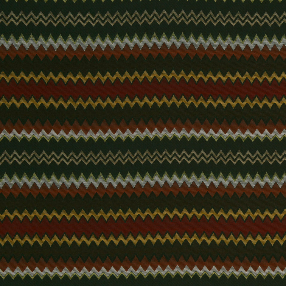 Earth-toned chevron stripe upholstery fabric pattern in olive green, burgundy, rust, gold, and charcoal zigzags.