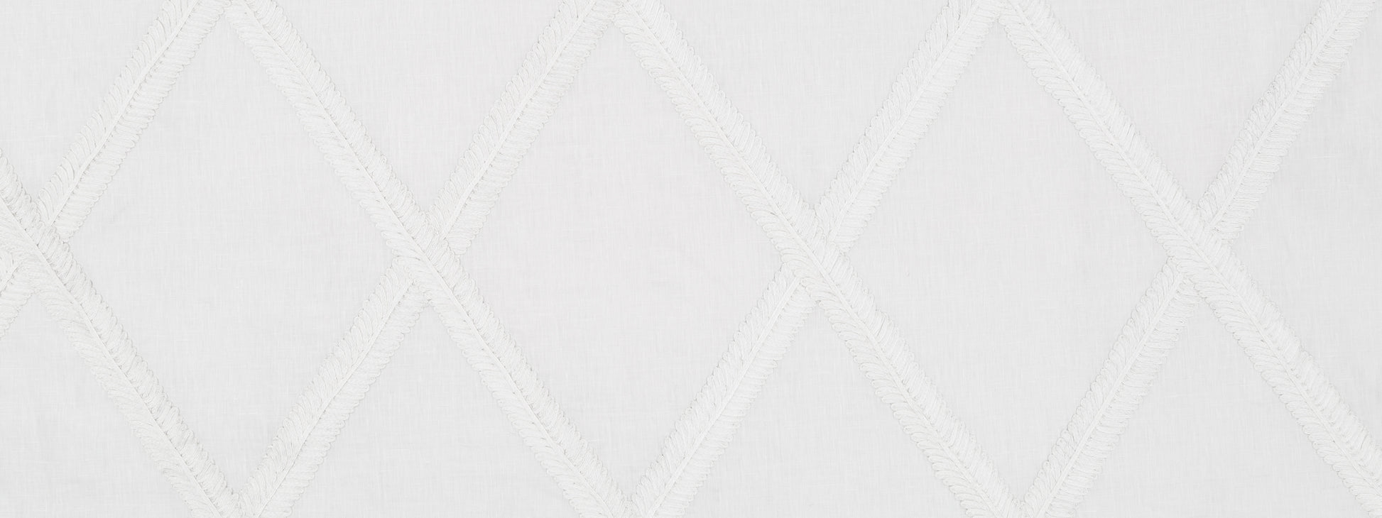 White quilted fabric with diagonal diamond stitching pattern; soft textile suitable for bedding or upholstery.