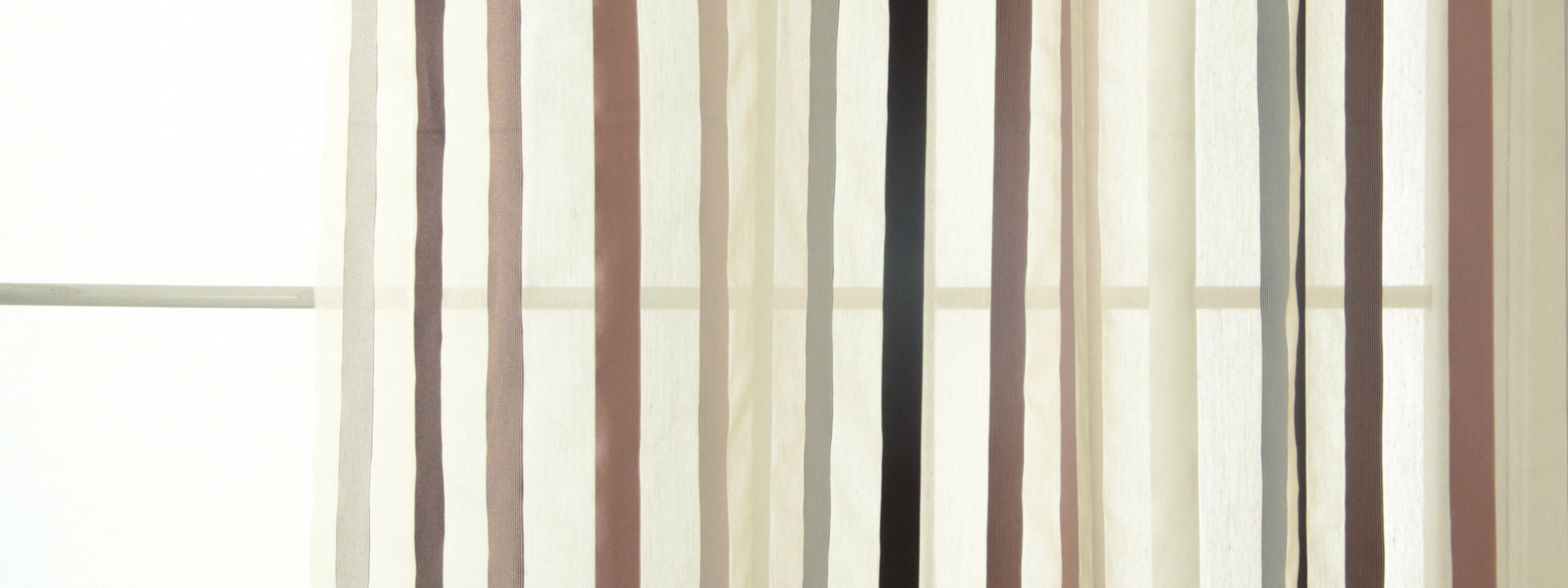 Sheer vertical striped curtains in beige, tan and cream tones, light-filtering window decor.
