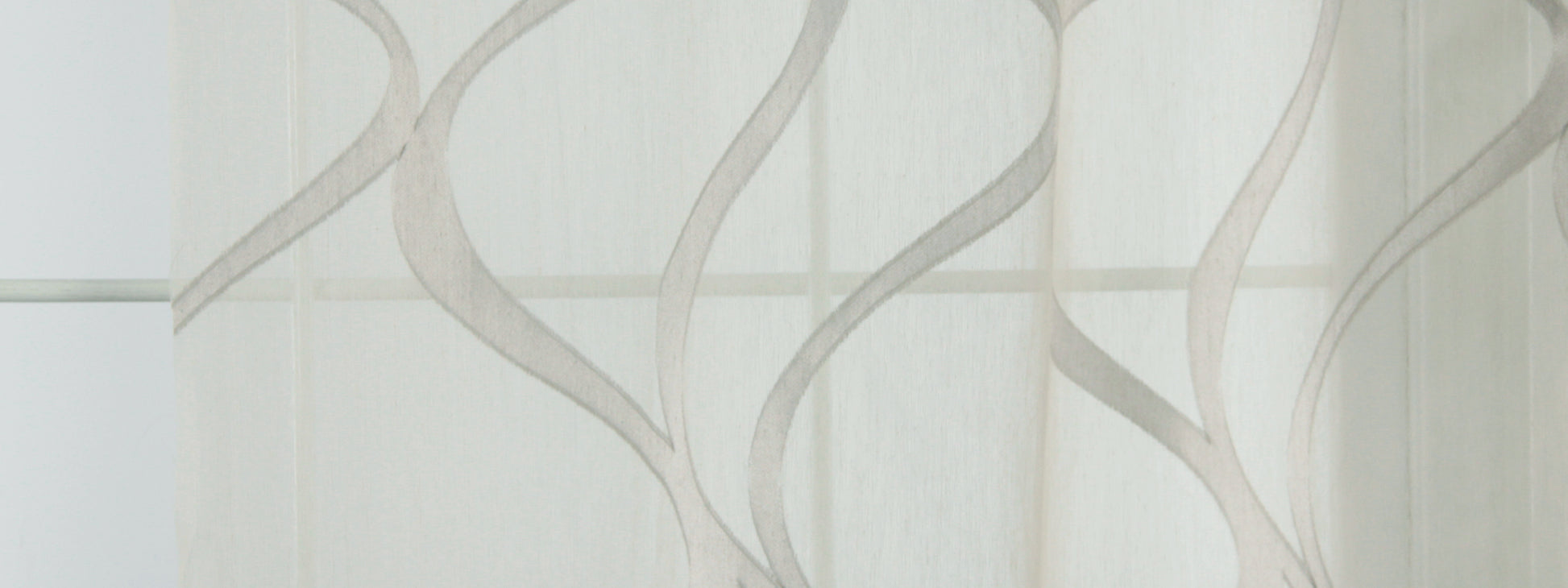 Sheer white curtain with taupe wavy vine pattern, lightweight window drapery for modern decor.