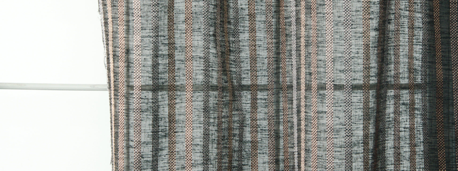 Close-up of grey & black striped woven curtain fabric with subtle beige accents, textured drapery.