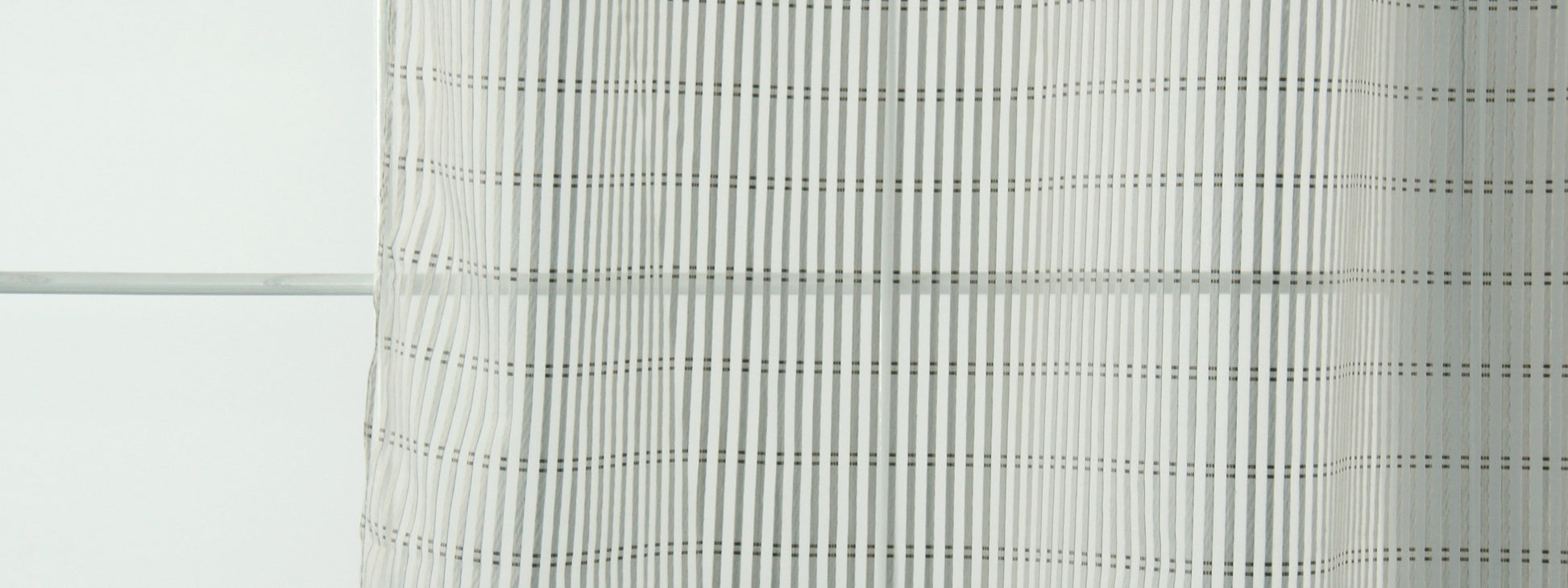 White sheer curtain with subtle grey grid stripes, lightweight window panel.