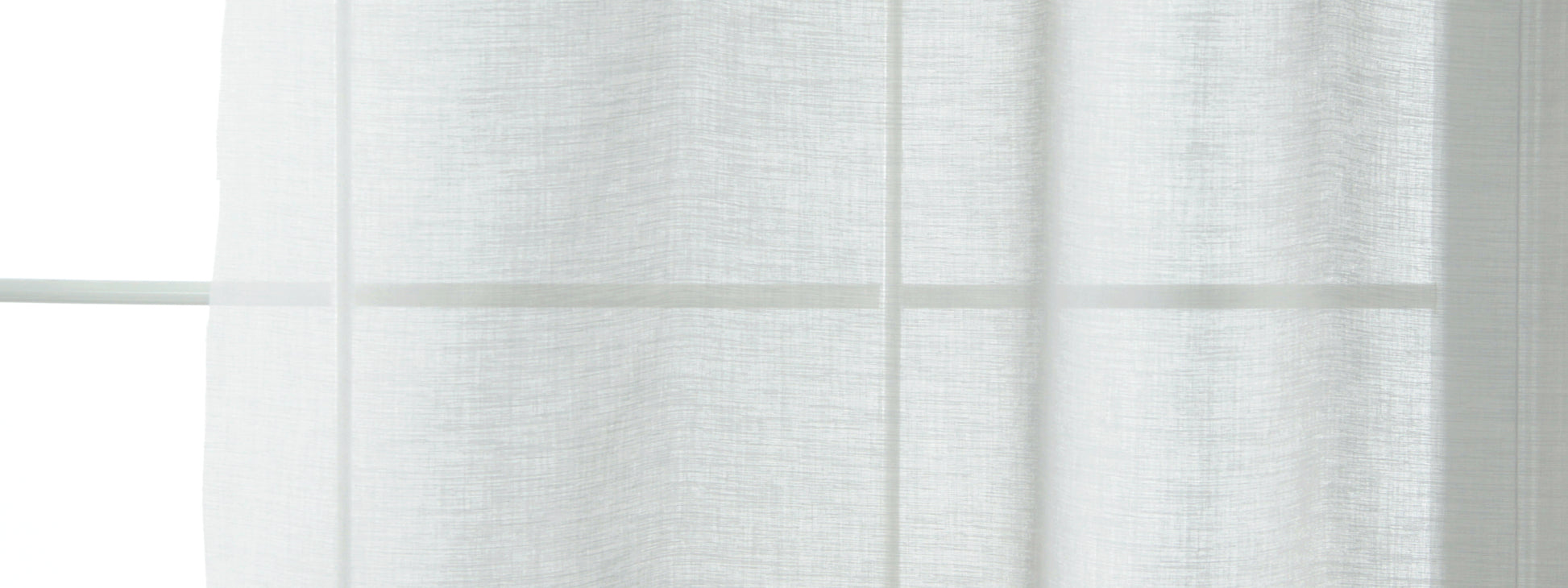 White sheer curtains draped over a window, light-filtering, airy minimalist style.