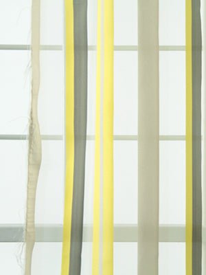Vertical striped citron, gray and beige drapery panels with a sheer left panel; modern minimalist window treatment.