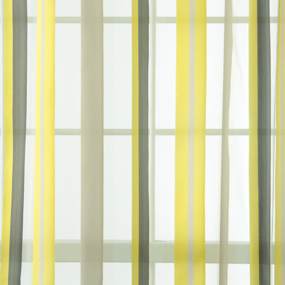 Yellow, gray, and off-white striped sheer curtains framing a window.