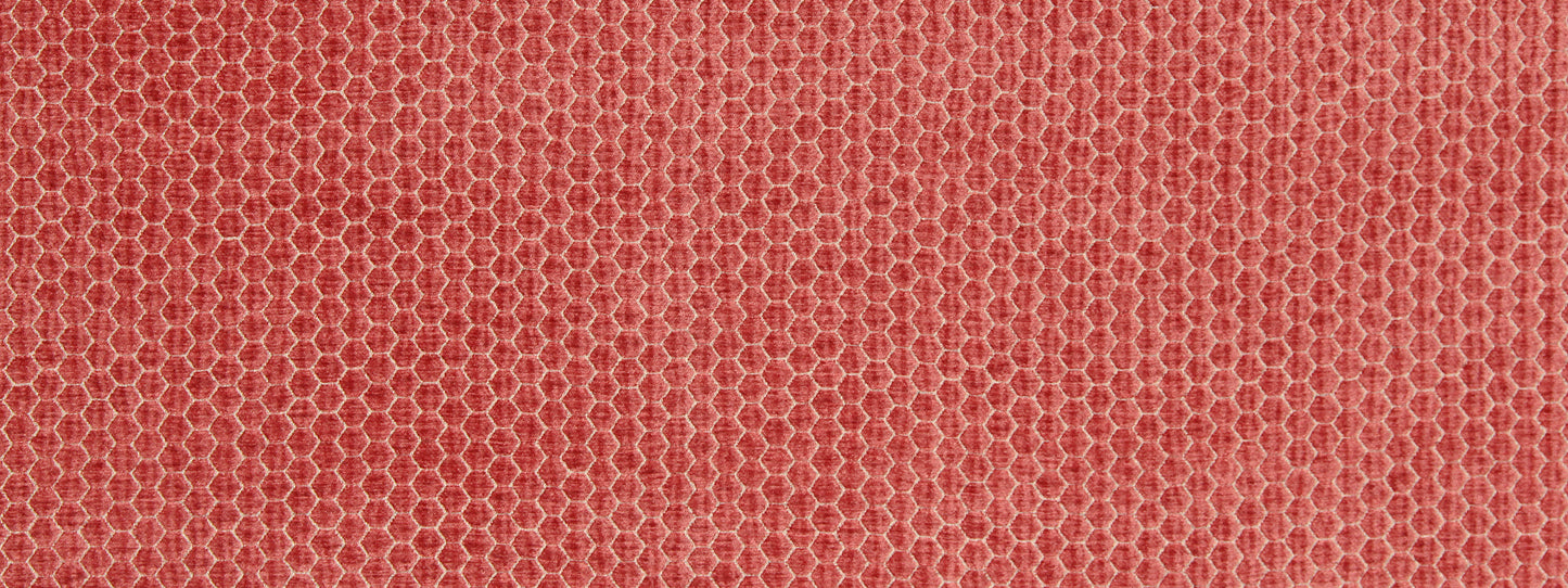 Coral upholstery fabric close-up with a honeycomb texture and mesh-like pattern.