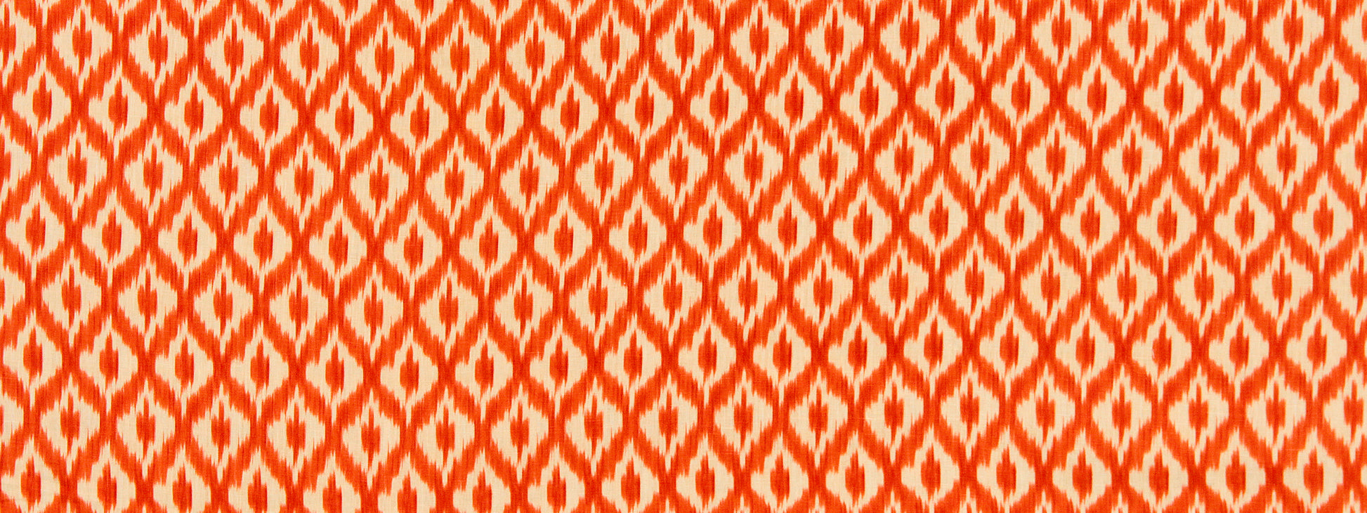 Orange and white geometric ikat-patterned fabric with repeated diamond motifs.