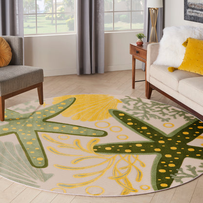 Outdoor round rug with an abstract green-yellow leaf pattern.