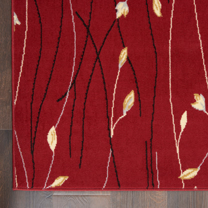 Red rug with black wavy vines and small beige-yellow leaves, bordered edge, on a wood floor.